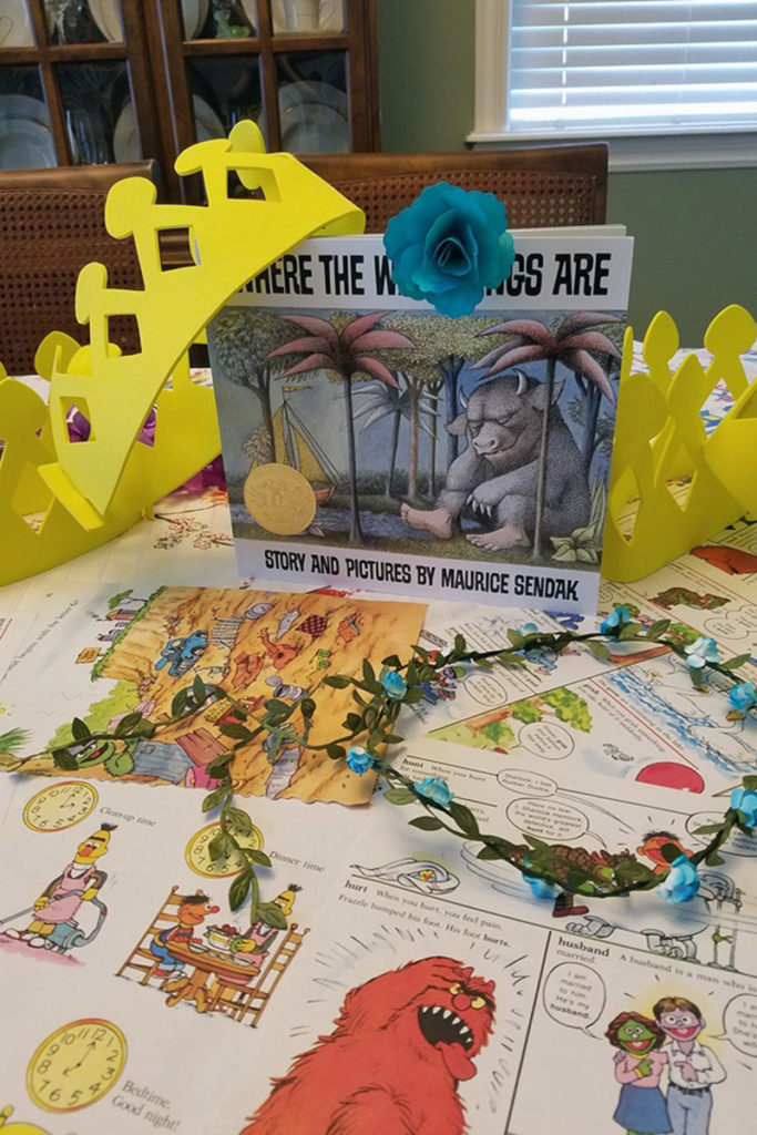 Books and toy crowns for kids on table