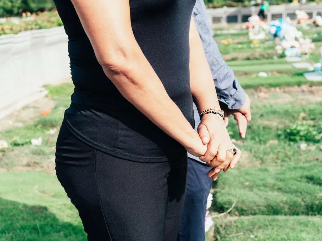 Family Members Saying Their Final Goodbyes At A Burial Site | Eternally Loved