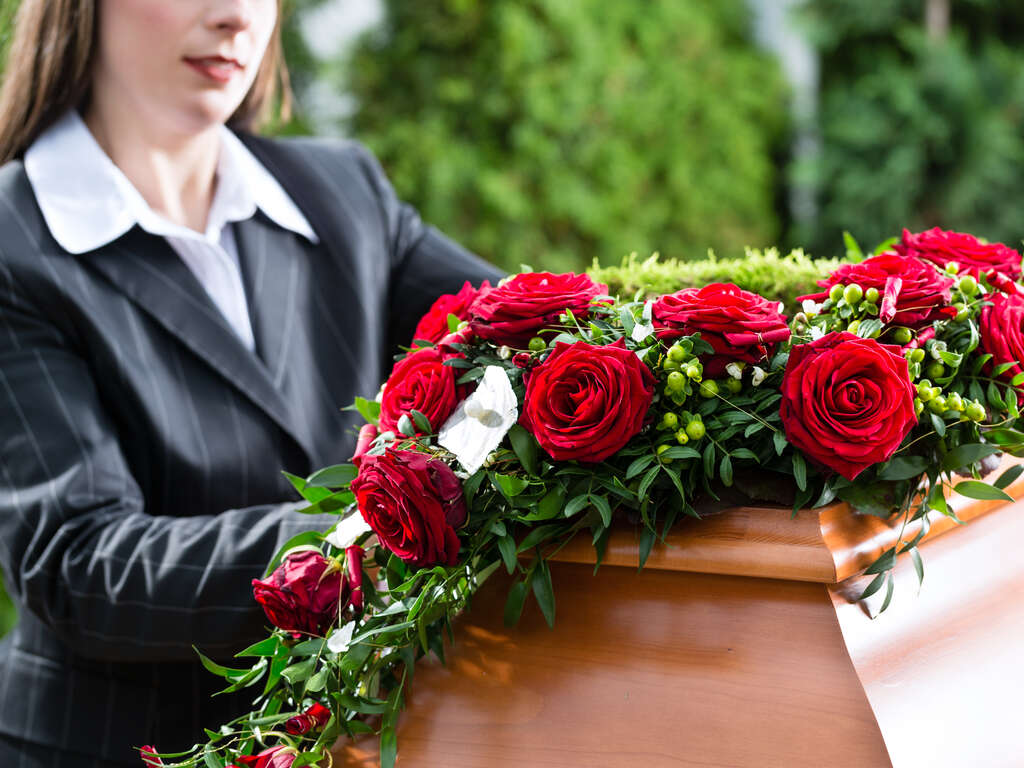 Funeral Director Displaying Funeral Flowers | Eternally Loved